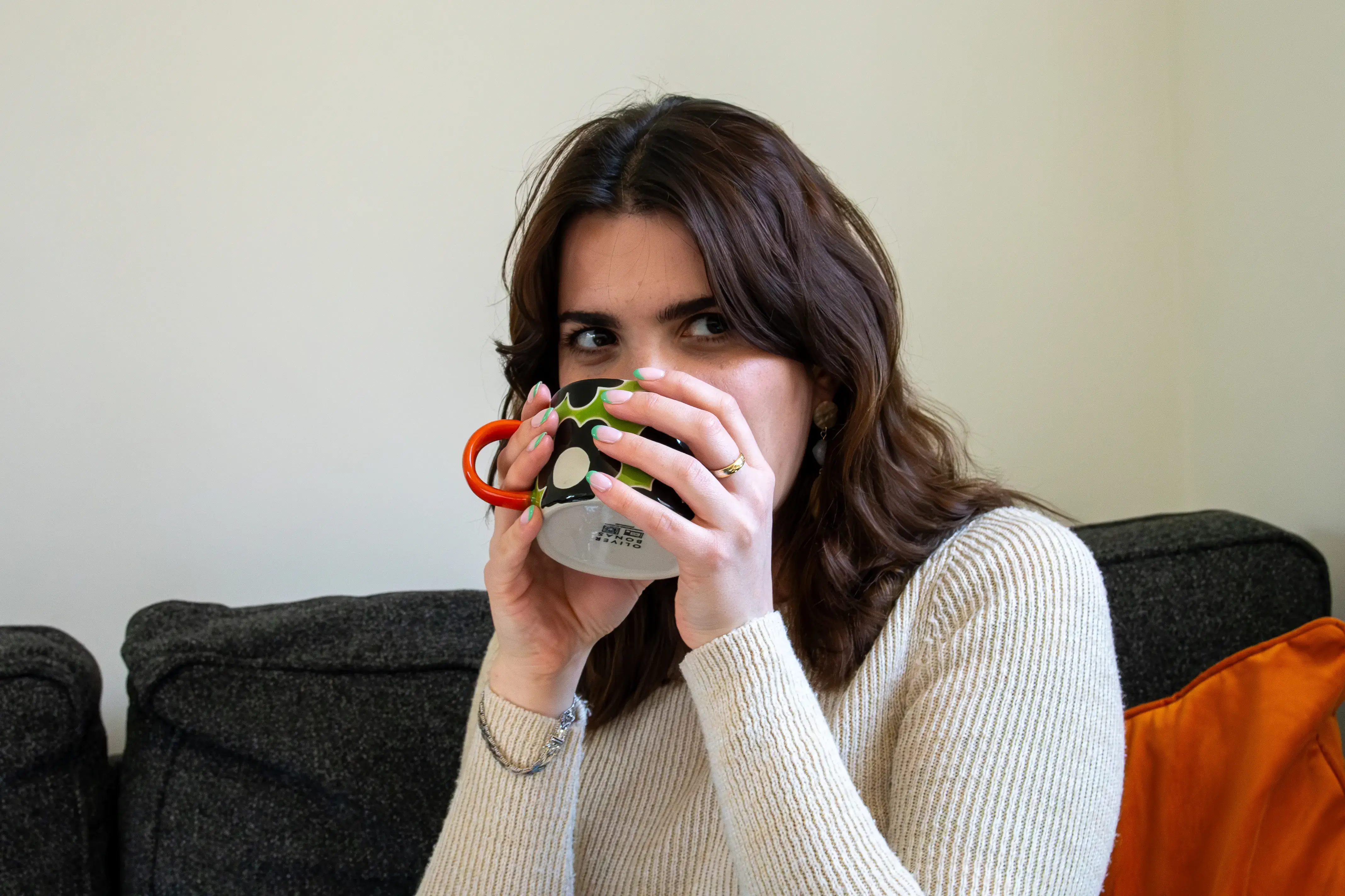 A female small business owner drinking a cup of coffee